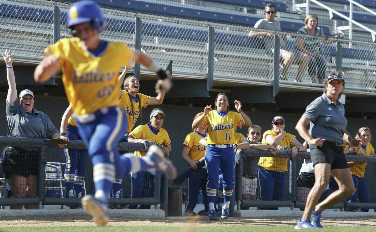 Hannah Michael scores the tying run for St. Mary’s in the seventh inning against Rogers State as coach Donna Fields (right) begins to celebrate on March 24, 2017.