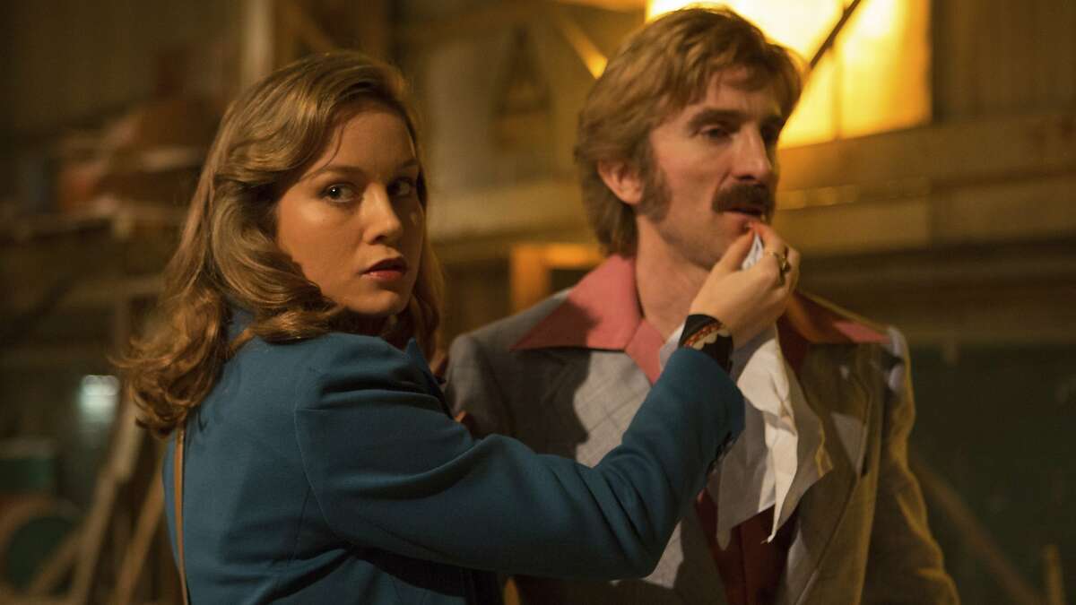 This image released by A24 shows Brie Larson, left, and Sharlto Copley in a scene from "Free Fire." (Kerry Brown/A24 via AP)