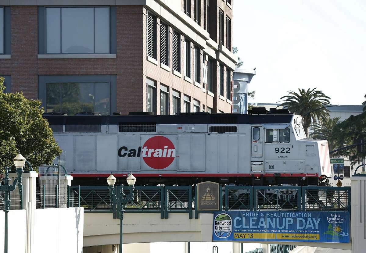 Caltrain rolls past the Box, Inc. headquarters office building located next to the train station in Redwood City, Calif. on Wednesday, April 19, 2017. Box is one of a few companies that has relocated to more transit-friendly environs and provides free Caltrain transit passes to its employees.