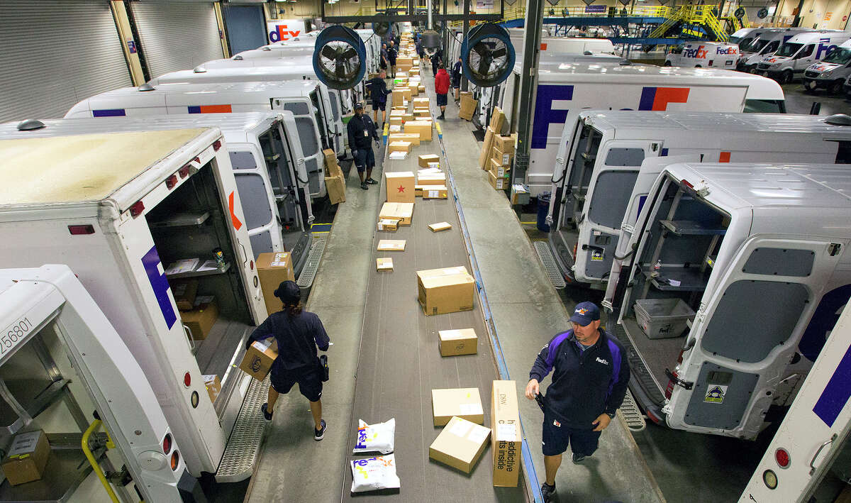 Employees sort packages at the FedEx Ship Center, during Cyber Monday, Monday, Nov. 30, 2015, in Houston. (Cody Duty / Houston Chronicle)