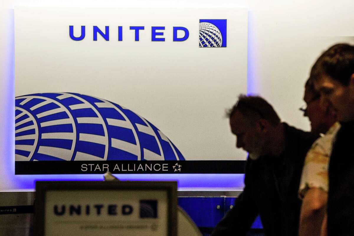 Passengers use United self check-in kiosks ﻿at the Newark, N.J., airport.