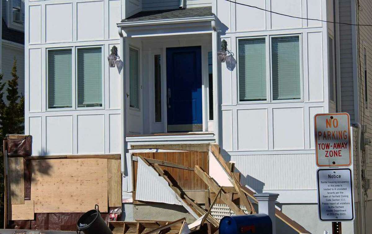 The driver of the pickup truck that took out the steps of this porch on Fairfield Beach Road has been arrested on a warrant for driving under the influence.