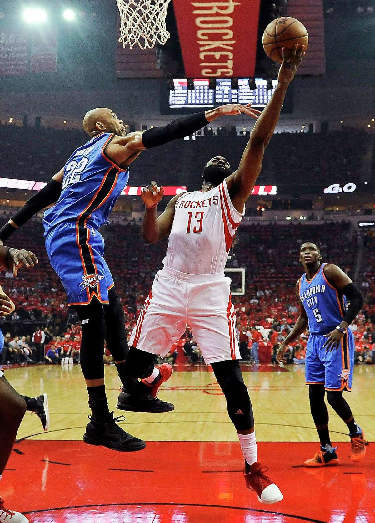 Houston Rockets guard James Harden (13) shoots as Oklahoma City Thunder forward Taj Gibson defends during the first half in Game 2 of an NBA basketball first-round playoff series, Wednesday, April 19, 2017, in Houston. (AP Photo/Eric Christian Smith)