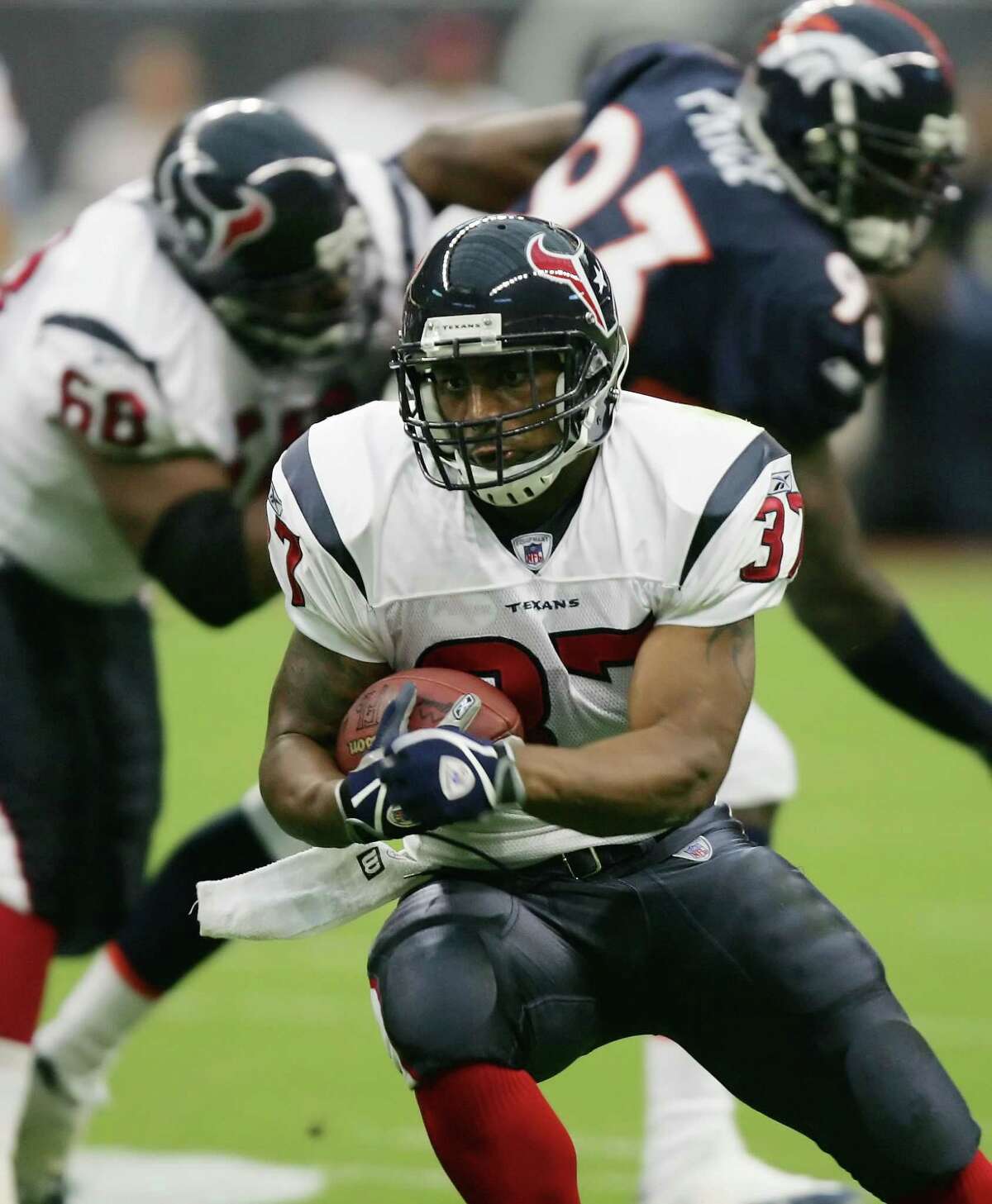 Houston Texans running back Domanick Davis, front, runs for a gain during the first quarter of a preseason game against the Denver Broncos, Aug. 13, 2005, in Houston. After rushing for more than 1,000 yards in each of his first two professional seasons, the Texans scrapped his rookie contract and rewarded him with a new, far more lucrative one. But even as he emerges as one of the more productive backs in the league, Davis has remained humble and is determined to do more. (AP Photo/David J. Phillip, File)