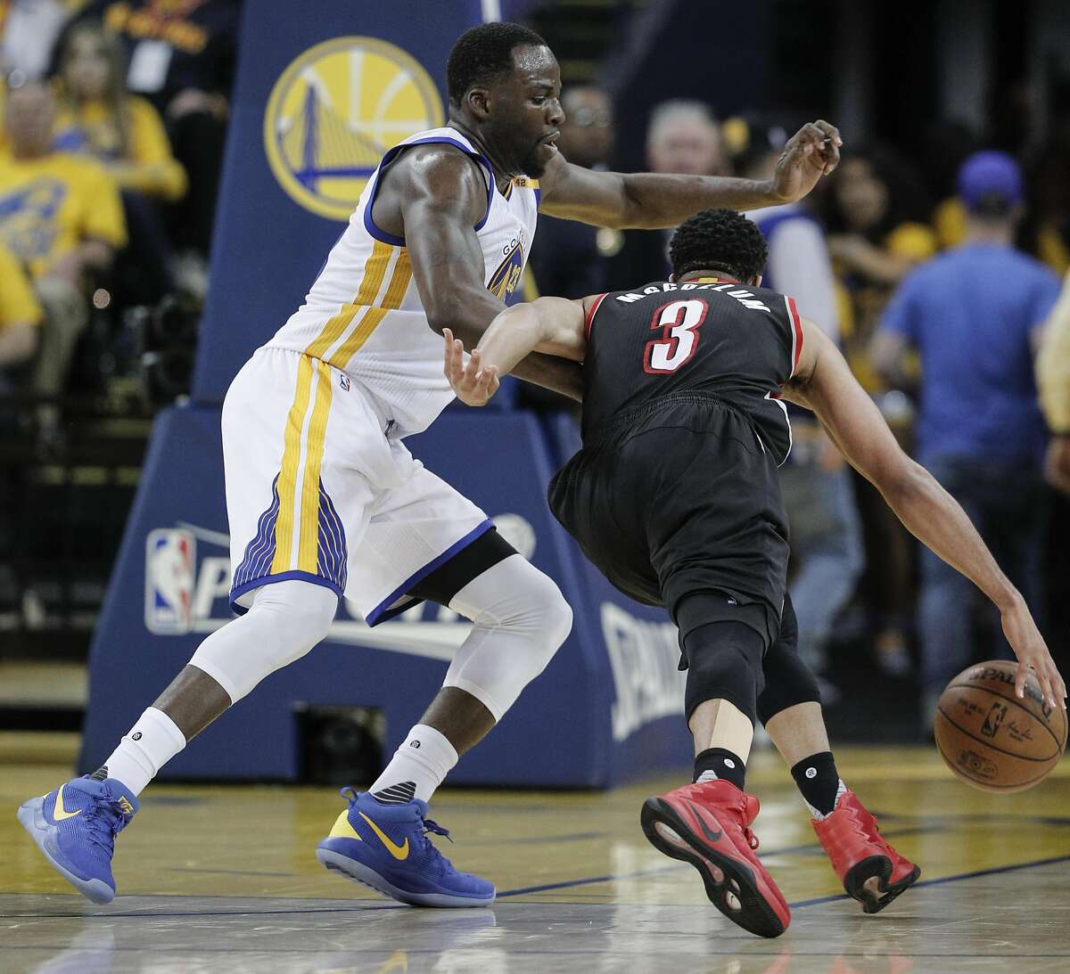 Golden State Warriors' Draymond Green guards Portland Trail Blazers' CJ McCollum in the third quarter during Game 2 of the First Round of the Western Conference 2017 NBA Playoffs at Oracle Arena on Wednesday, April 19, 2017 in Oakland, Calif.