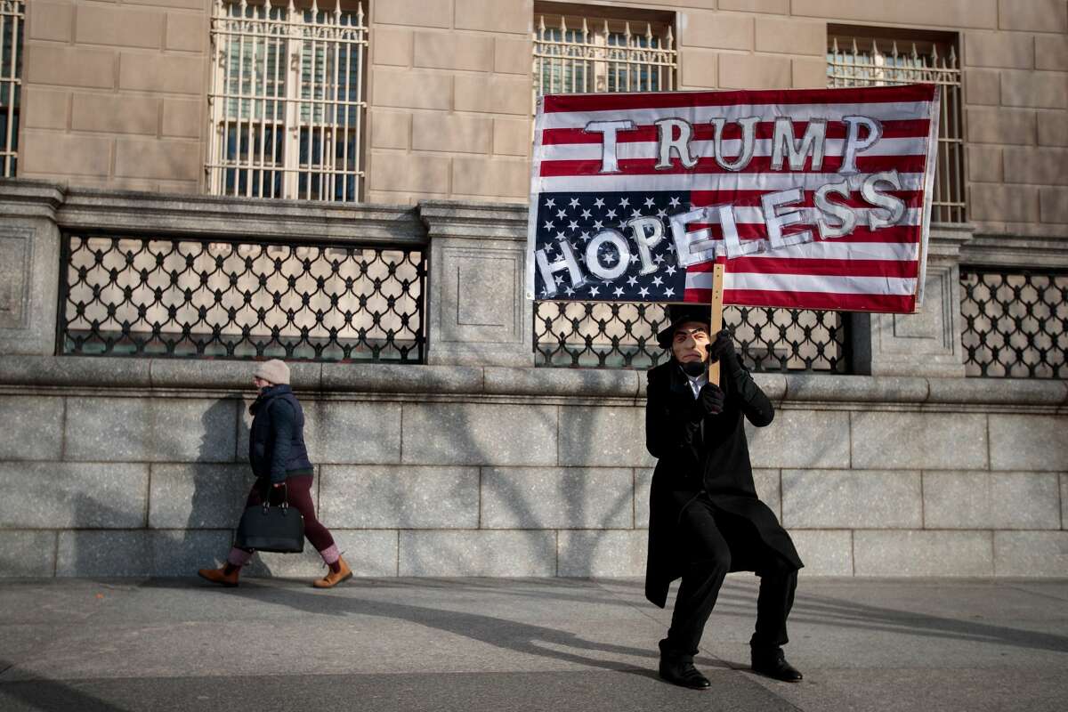 Dressed as Abraham Lincoln, an anti-Donald Trump demonstrator walks along Pennsylvania Avenue near the White House, January 27, 2017 in Washington, DC.
