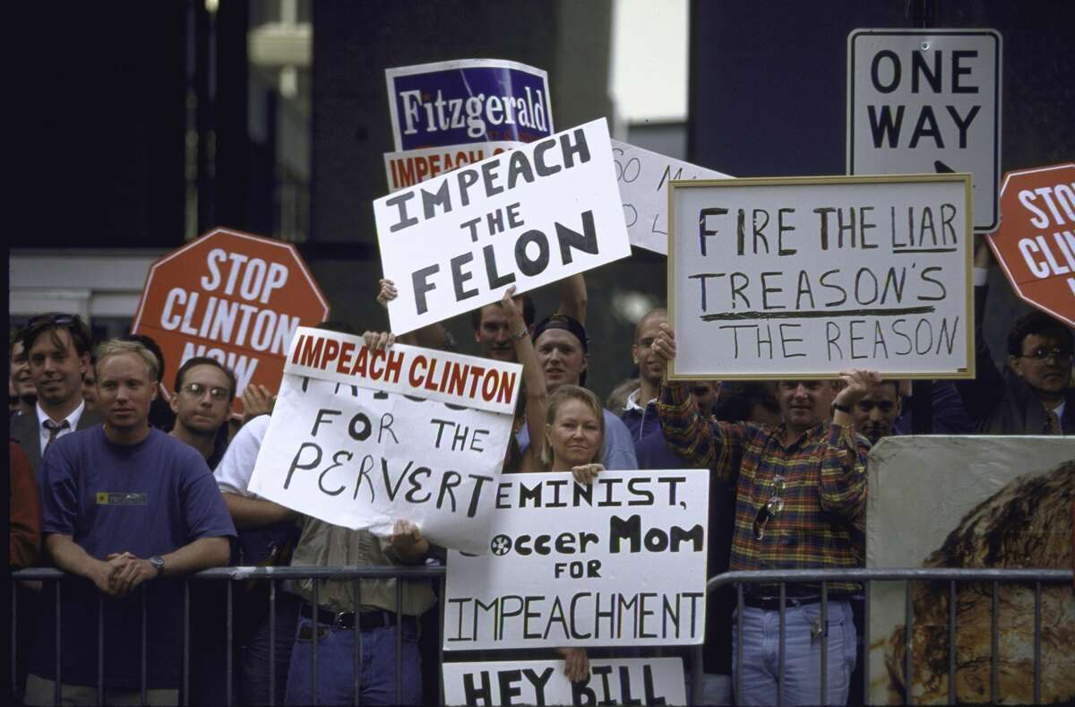 Protesters waving signs calling for Pres. Bill Clinton's impeachment re his affair with White House intern Monica Lewinsky in 1998.