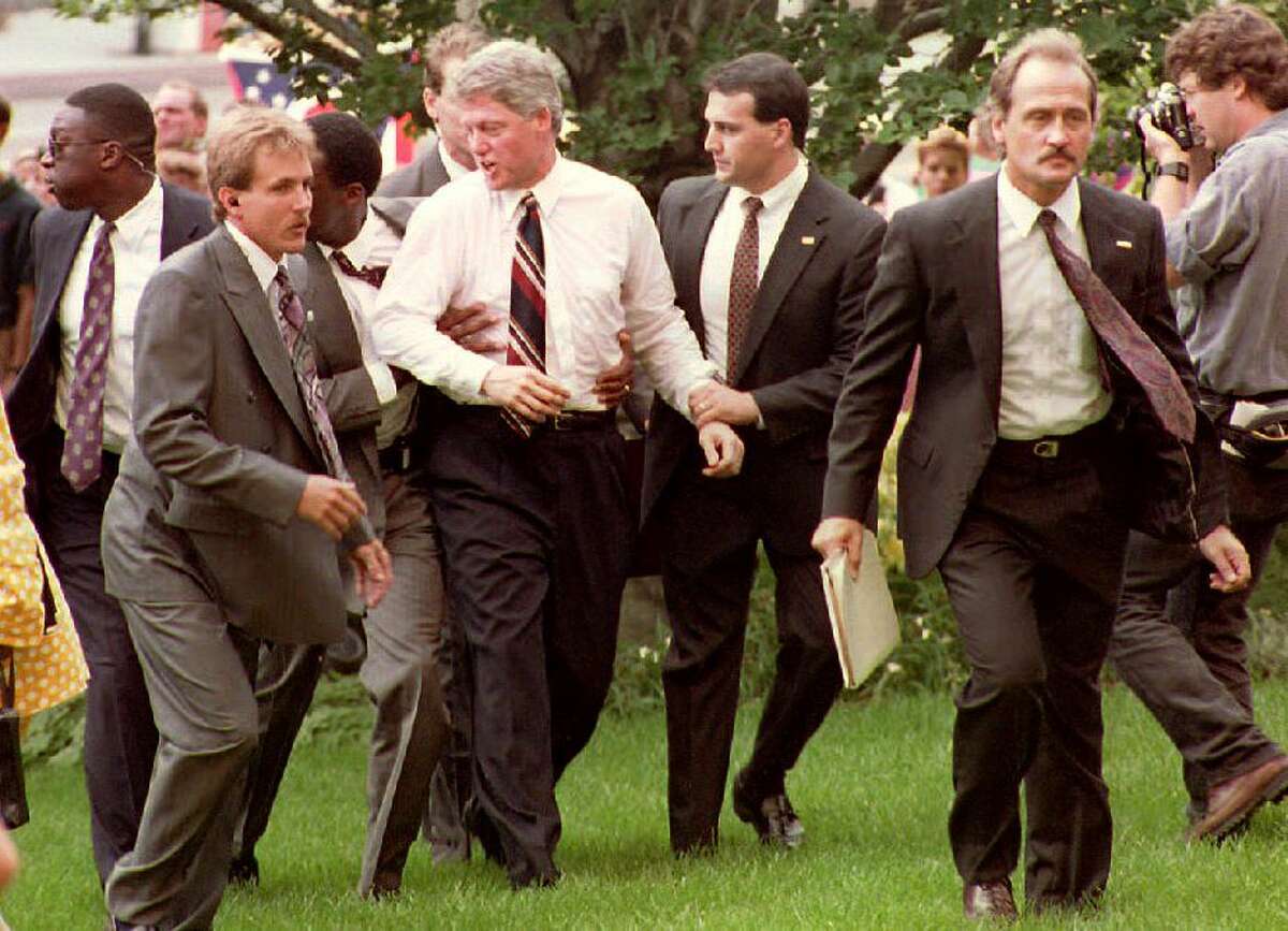 Democratic presidential candidate Bill Clinton is escorted away from a crowd by U.S. Secret Service agents 20 July after an anti-abortion protester moved towards the Arkansas governor during a rally. Clinton is stopping in a number of Ohio cities during his bus tour.