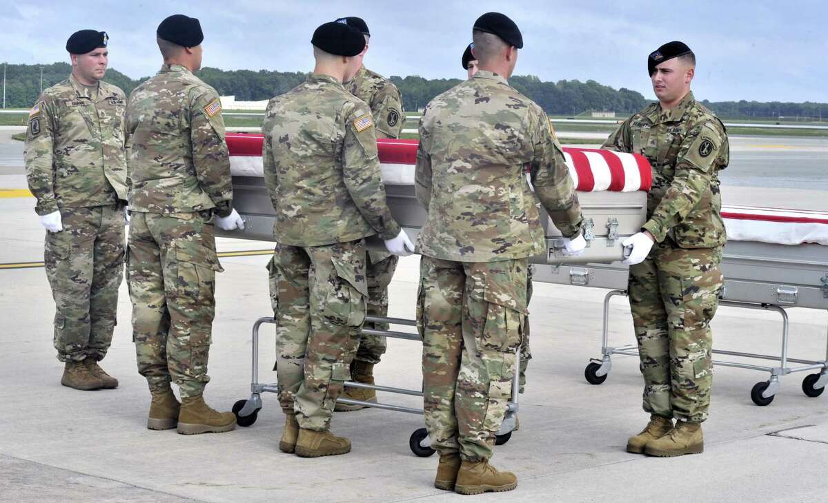 Members of the Army "Old Guard" unit escort remains thought to be those of U.S. troops who died in the Mexican-American War as they arrived at at Dover Air Force Base in Dover, Del., Wednesday, Sept. 28, 2016. The remains thought to be those of U.S. troops who died in the Mexican-American War have been flown to a military mortuary in Delaware in an effort to determine whether they belonged to militia members of a Tennessee regiment known as "The Bloody First." (Gary Emeigh/The Wilmington News-Journal via AP)