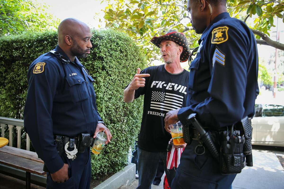 David Tomes (center) of Marin County chats with police sergeant Spencer Fomby (right) and Jumaane Jones (left) at Caffe Strada during a police community engagement event in Berkeley, California, on Wednesday, April 19, 2017.