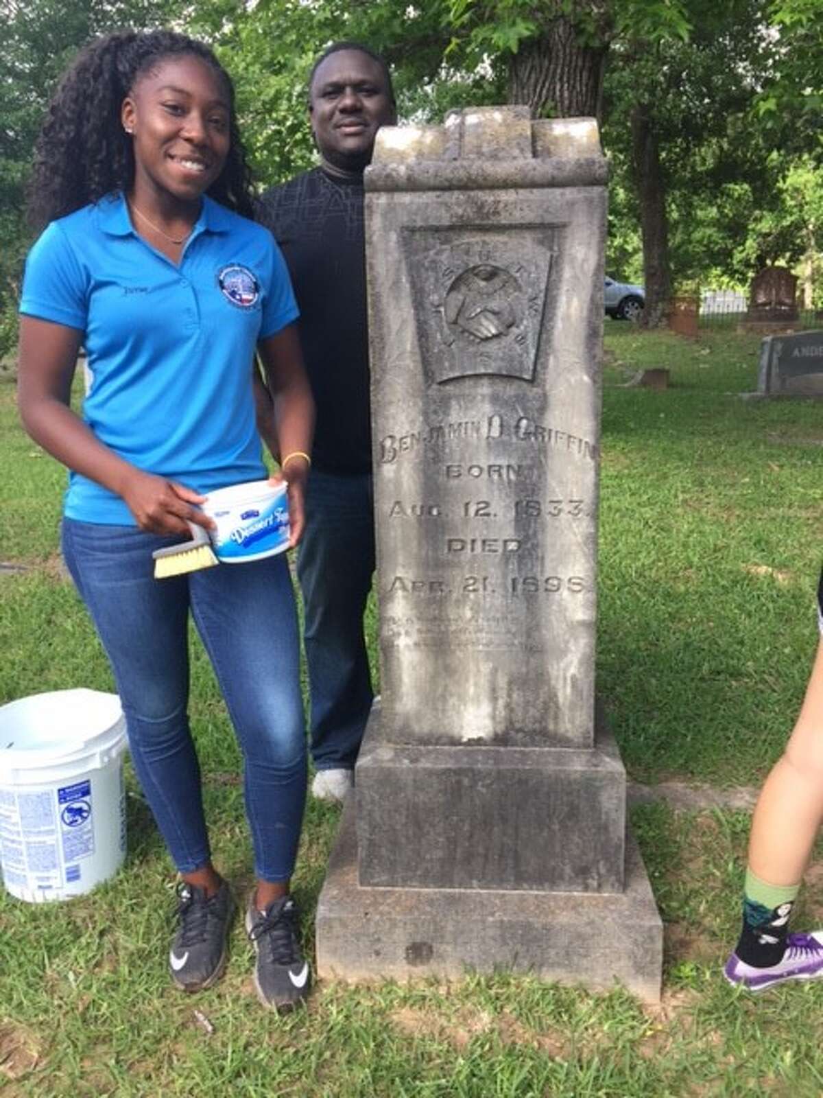 Youth Advisory Board member Juvae Williams and her dad, Dwight Williams, cleaned the tombstone of Benjamin D. Griffin. Benjamin D (BD) Griffin was a Montgomery County Clerk and leader in the late 1800s.