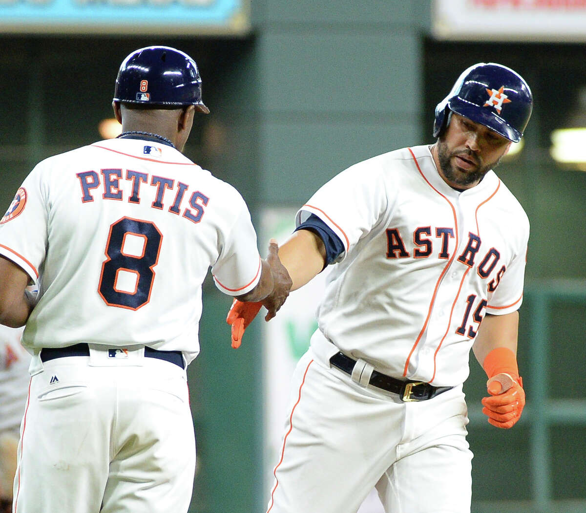Houston Astros' Carlos Beltran (15) is congratulated by third base coach Gary Pettis after hitting a solo home run against the Los Angeles Angels in the first inning Thursday in Houston.