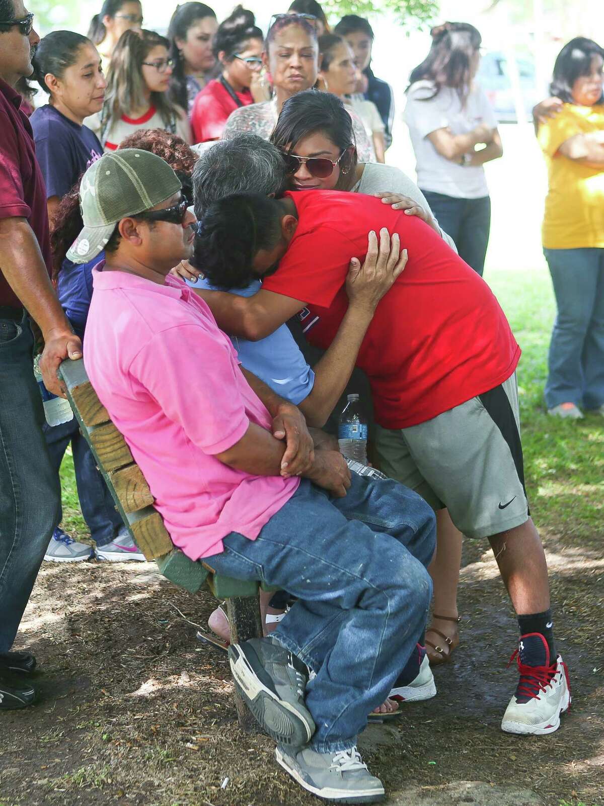 Family members mourn at a vigil at Peppermint Park where 13-year-old Juan Borja was shot and killed Wednesday night, during an afternoon gathering at the park, Thursday, April 20, 2017, in Freeport.