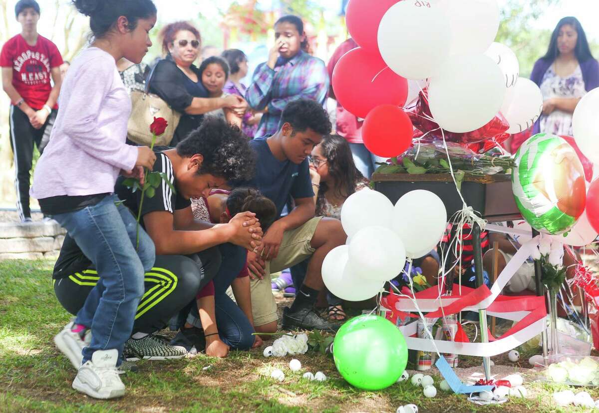 Family members mourn at a vigil at Peppermint Park where 13-year-old Juan Borja was shot and killed Wednesday night, during an afternoon gathering at the park, Thursday, April 20, 2017, in Freeport.