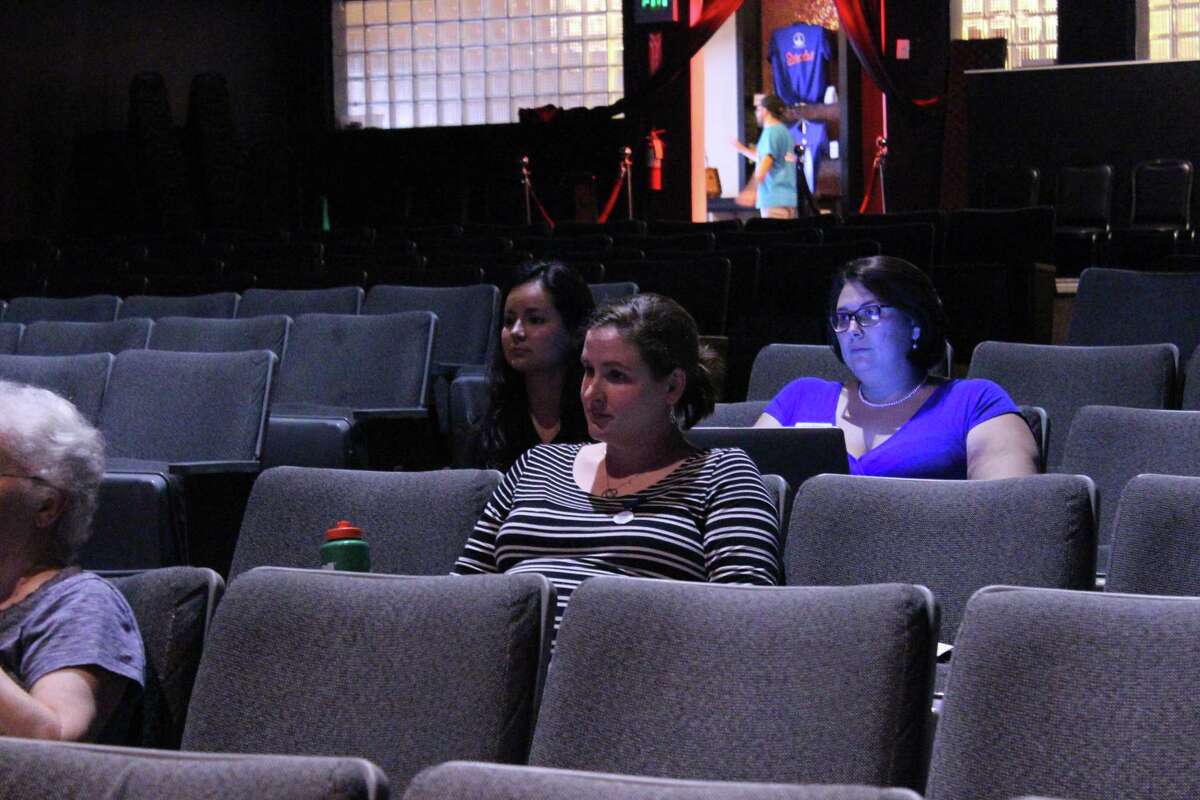 From left, San Antonio March for Science organizers Alex Mora, Grace Barnett and Sara Beesley listen at a volunteer meeting at Woodlawn Theatre on April 19, 2017.