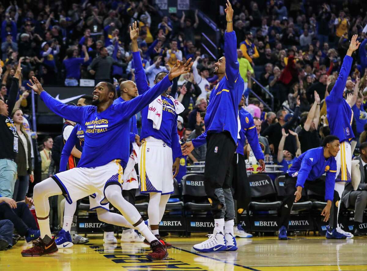 Golden State Warriors' basketball team reacts after Klay Thompson scored a 3-pointer in a game against the Indiana Pacers, in Oakland, California, on Monday, Dec. 5, 2016.