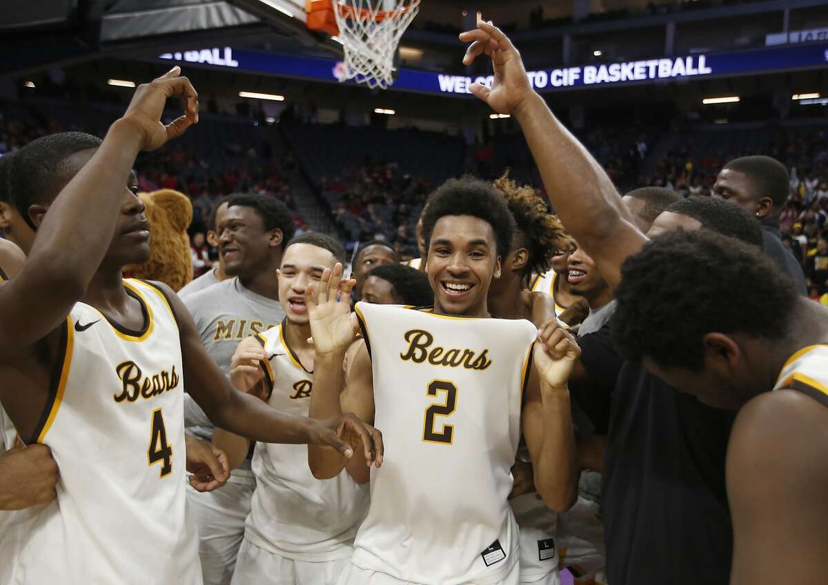 Mission High guard Jamion Wright, center, celebrates with his teammate after their overtime win over Villa Park High in the boys CIF division III high school basketball championship game, Friday, March 24, 2017, in Sacramento, Calif. (AP Photo/Rich Pedroncelli)