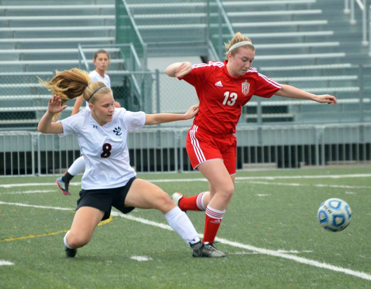 Edwardsville defender Sarah Kraus, left, attempts to tackle the ball away from a Chatham Glenwood player during first-half action inside the District 7 Sports Complex.