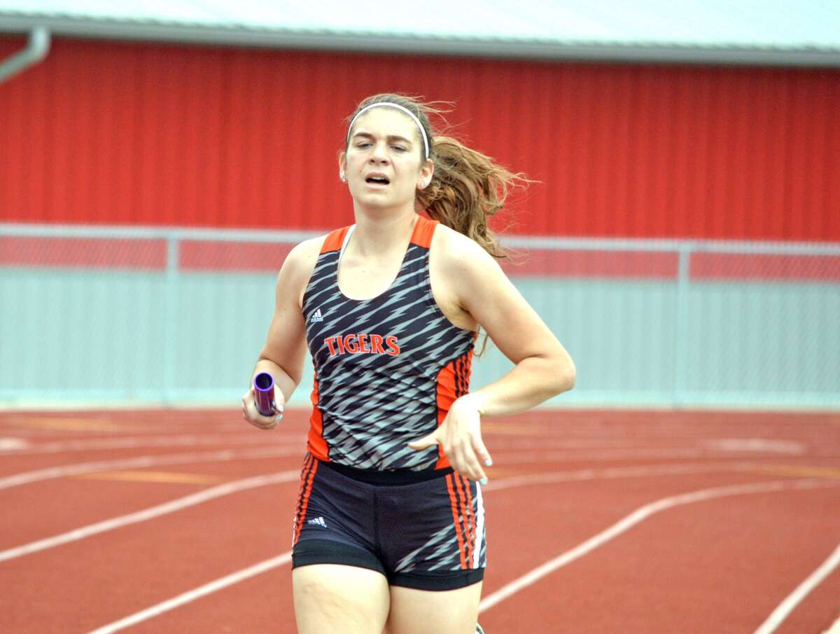 Edwardsville junior Haley Allard competes in the second leg of the 3,200-meter relay during the Alton Invitational on Thursday.