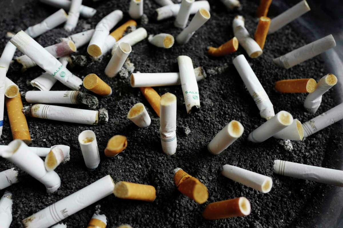 FILE - In this April 7, 2017, file photo, cigarette butts are discarded in an ashtray in New York City.