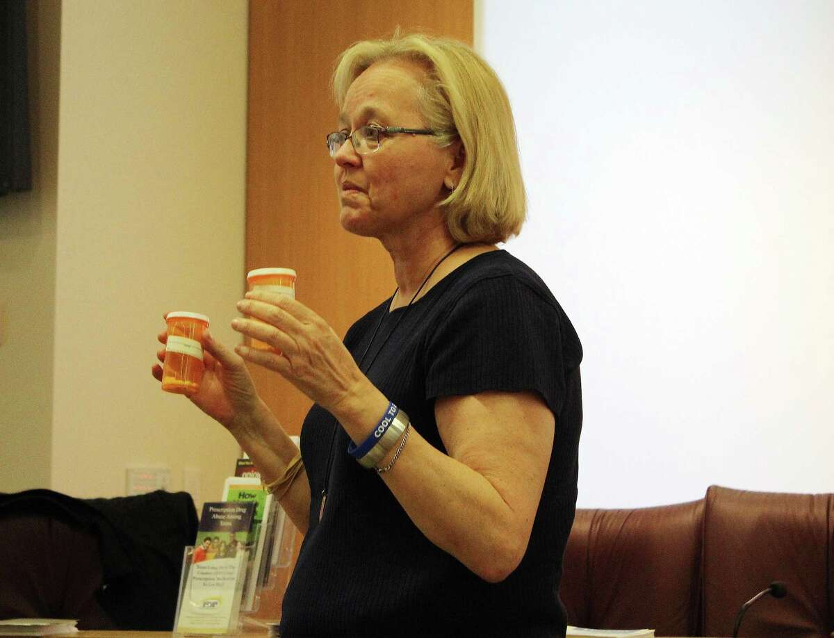Ingrid Gillespie holds up prescription painkillers at a Narcan training event in New Canaan, CT on April 18, 2017.