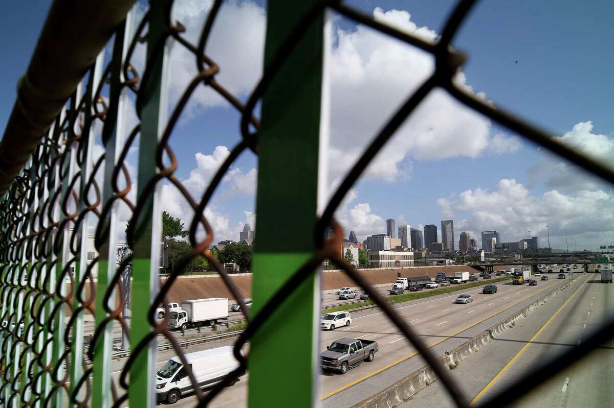 One-inch-wide strips of Coroplast have been threaded through the chain-link fence, installed during the '50s, forming colorful murals that seem to float above the freeway.