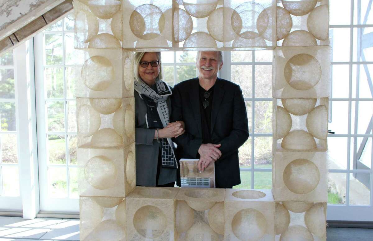 Wilton couple Rhonda Brown and Tom Grotta behind one of the featured art inside their home gallery at 276 Ridgefield Road.