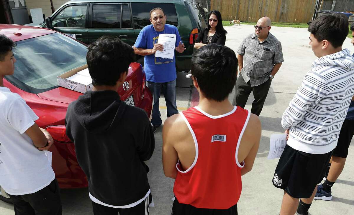 Jason Mata, center, a leader of the Prospect Hill Neighbhorhood Association and head of a youth boxing program, instructs volunteers April 14, 2017, on how to gather signatures for a petition requesting a police storefront on North Zarzamora Street in Prospect Hill.