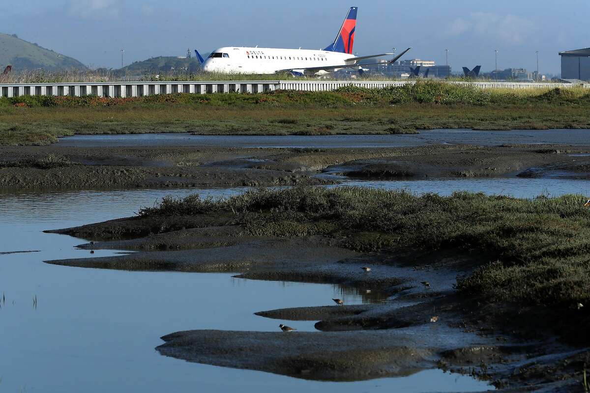 The runways and taxiways at San Francisco International airport are at risk from the coming sea level rise due to climate change, as seen on Wed. April 19, 2017, in San Francisco, Calif.