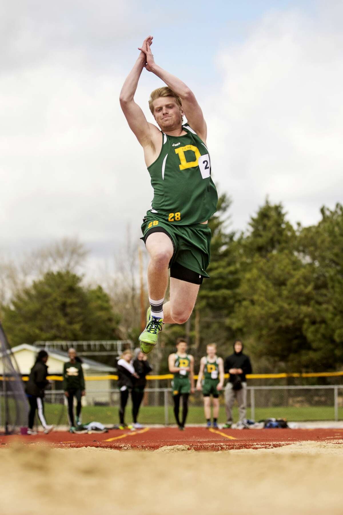 Dow's Zack Coon competes in the long jump on Friday during the Graves/Swayze Relay Meet at Midland Community Stadium.