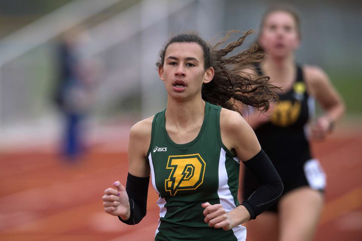 BRITTNEY LOHMILLER | blohmiller@mdn.net Dow's Maija Rettelle races in the 4x6400 relay during the Graves/Swayze Relays Friday afternoon at the Midland Stadium.