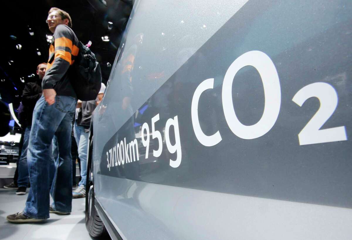 FILE - In this Sept. 22, 2015, file photo, the amount of carbon dioxide emissions is written on a Volkswagen Passat Diesel at the Frankfurt Car Show in Frankfurt, Germany. On Friday, April 21, 2017, a judge ordered Volkswagen to pay a $2.8 billion criminal penalty in the United States for cheating on diesel emissions tests, blessing a deal negotiated by the government for a ?“massive fraud?” orchestrated by the German automaker. (AP Photo/Michael Probst, File) ORG XMIT: NYBZ562