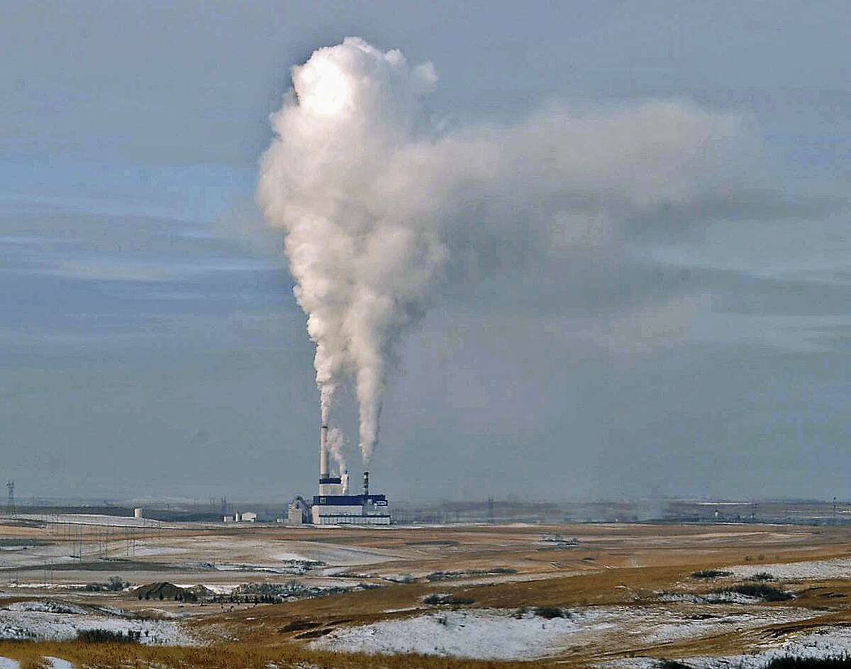 FILE - In this Jan. 30, 2008, file photo, steam rises from the coal-fired Milton Young Power Plant near Center, N.D. The Environmental Protection Agency, EPA has been roiled by turmoil during its first week under Trump, as members of the transition team issued what it has described as a temporary freeze on all contract approvals and grant awards. (Tom Stromme/The Bismarck Tribune via AP, File)