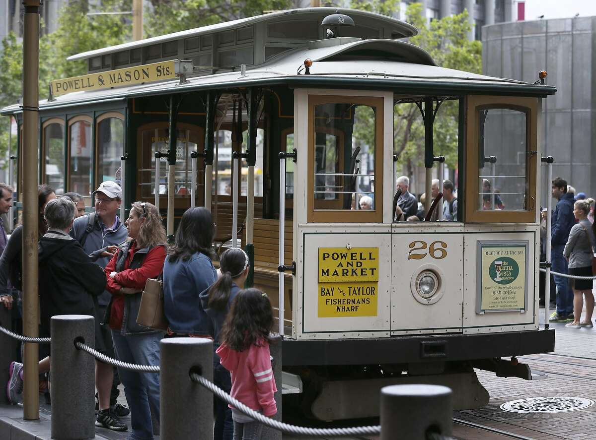 Passengers wait to board a cable car at Powell and Market streets in San Francisco, Calif. on Saturday, April 22, 2017. Muni may eliminate cash fares on board the world famous cable cars after a brakeman was accused of stealing the fares.