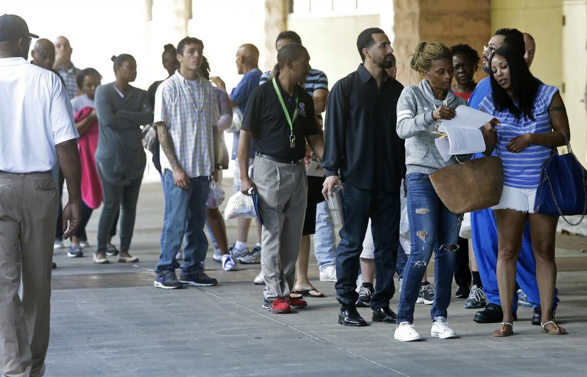 People wait in line to enter Lakewood Church, 3700 Southwest Fwy., for the Make It Right! event Saturday, April 22, 2017, in Houston. The program offers thousands of people a chance to clear up pending cases, including open warrants, for certain Class C Misdemeanors arising from cases filed in Harris County Precinct 1 and Precinct 6. Approximately 5,000 letters were mailed to eligible persons to inform them of this opportunity. A career and educational fair and free legal advice from volunteer defense lawyers regarding landlord-tenant issues, immigration, child support and other areas was also offered to the public. ( Melissa Phillip / Houston Chronicle )