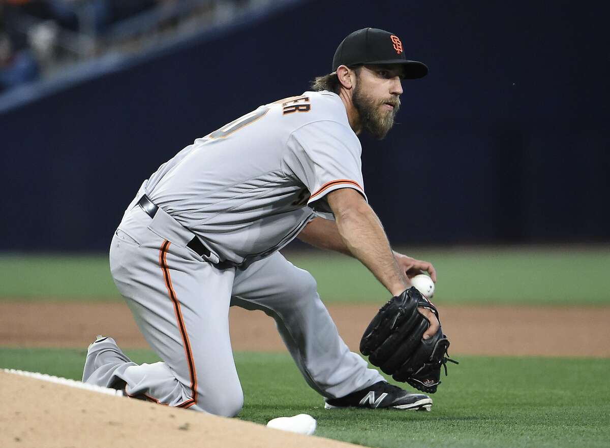 SAN DIEGO, CA - APRIL 8: Madison Bumgarner #40 of the San Francisco Giants can't make the throw on a single hit by Luis Sardinas #2 of the San Diego Padres during the fifth inning of a baseball game at PETCO Park on April 8, 2017 in San Diego, California. (Photo by Denis Poroy/Getty Images)
