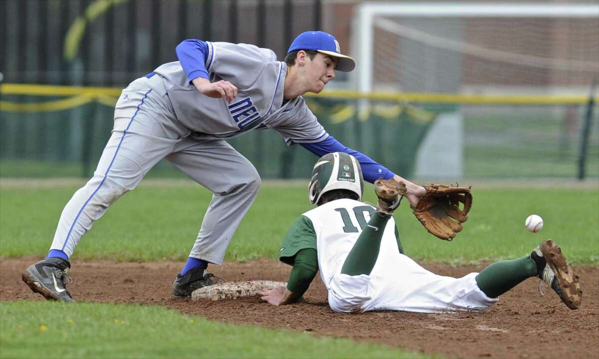 Newtown's Robert Murray (35) reaches for the throw as New Milford's Austin Swanson (10) slides safely into second in the baseball game between Newtown and New Milford high schools, Saturday, April 22, 2017, at New Milford High School, in New Milford, Conn.