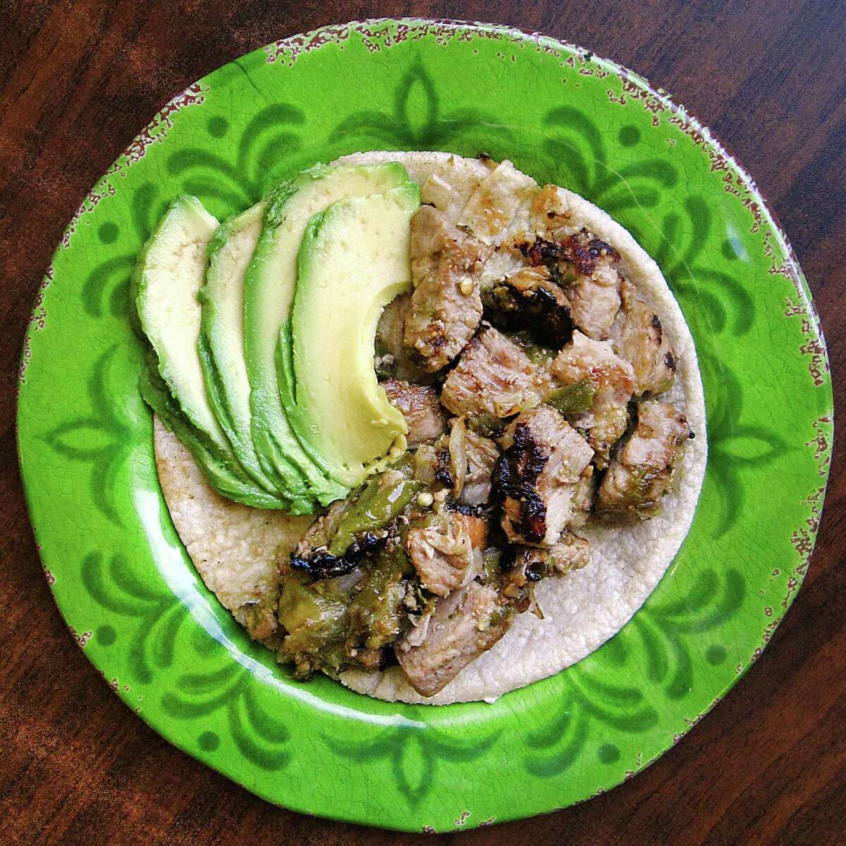 Pork with chile verde taco with avocado on a handmade corn tortilla from El Paraiso de Jalisco.