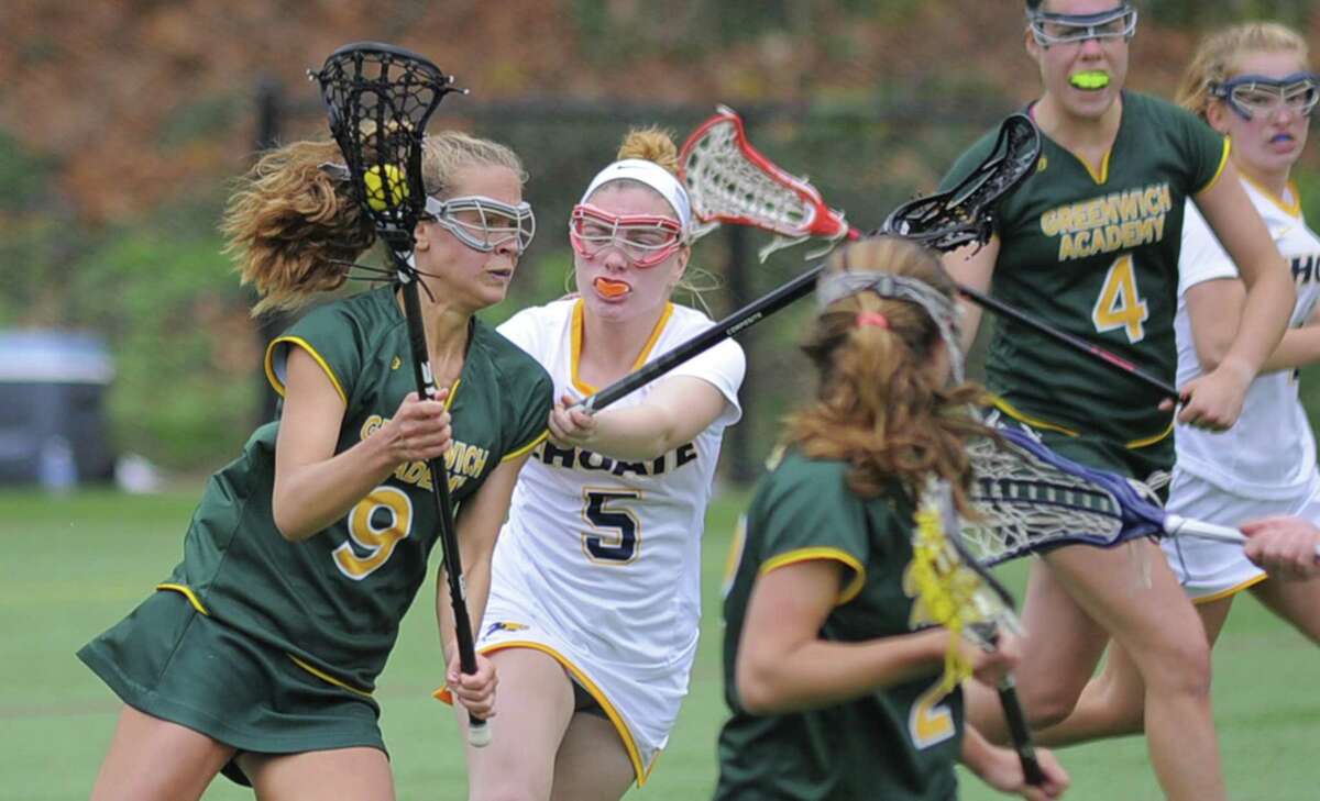 Greenwich Academy’s Karina Schulze (9) drives in for a score under pressure from Choate’s Christina Marciano during their game Saturday at Greenwich Academy. Greenwich Academy lost 13-8.