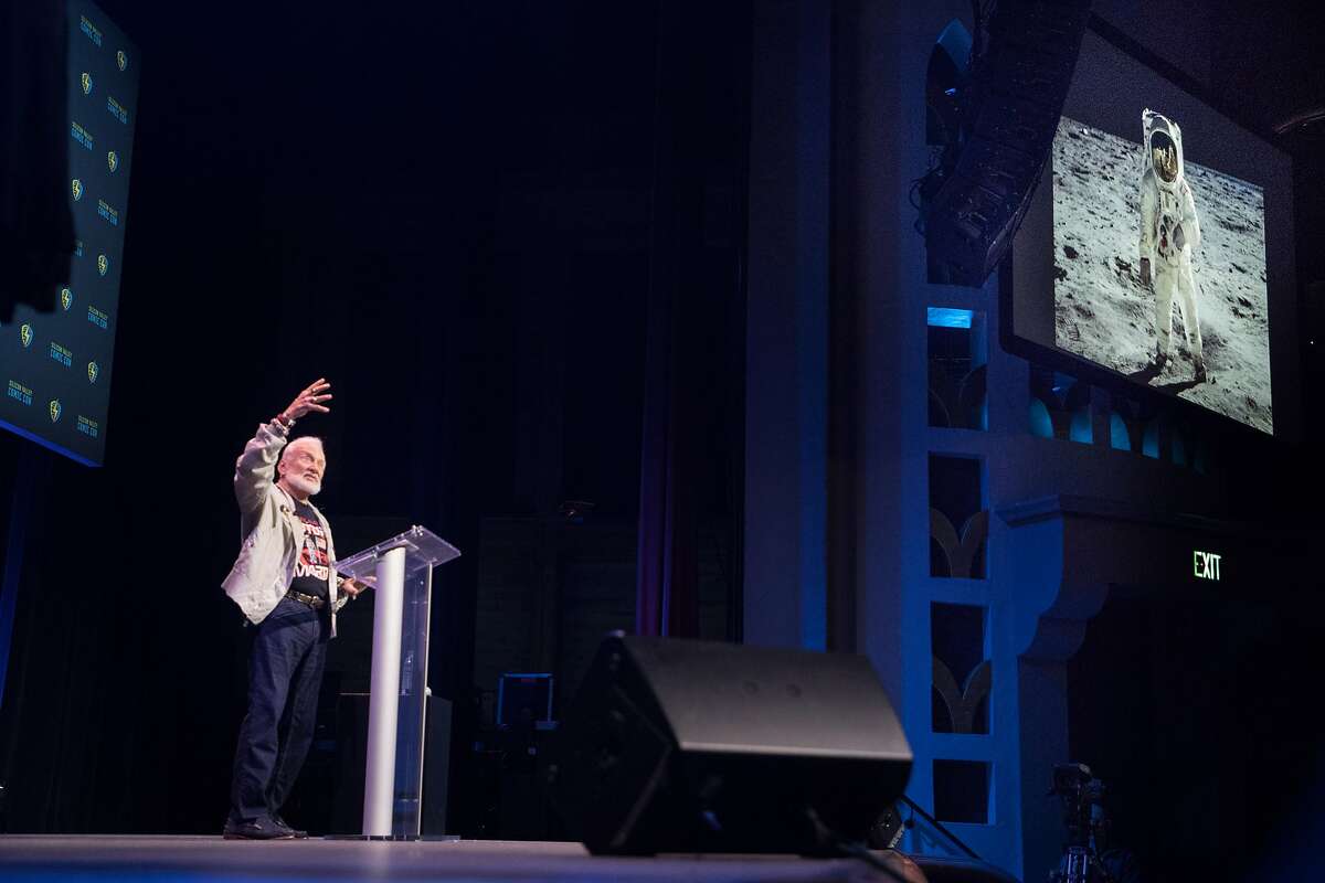 Astronaut Buzz Aldrin, with a photo of him on the moon projected, speaks at Santa Clara Comic Con on Saturday, April 22, 2017 in San Jose , CA. He is the second man to walk on the moon.