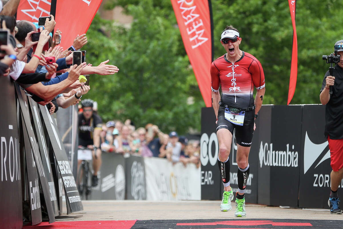 Matt Hanson, of Iowa, yells in jubilation as he approaches the finish line in first place during the Memorial Hermann IRONMAN North American Championship Texas on Saturday, April 22, 2017, in The Woodlands.