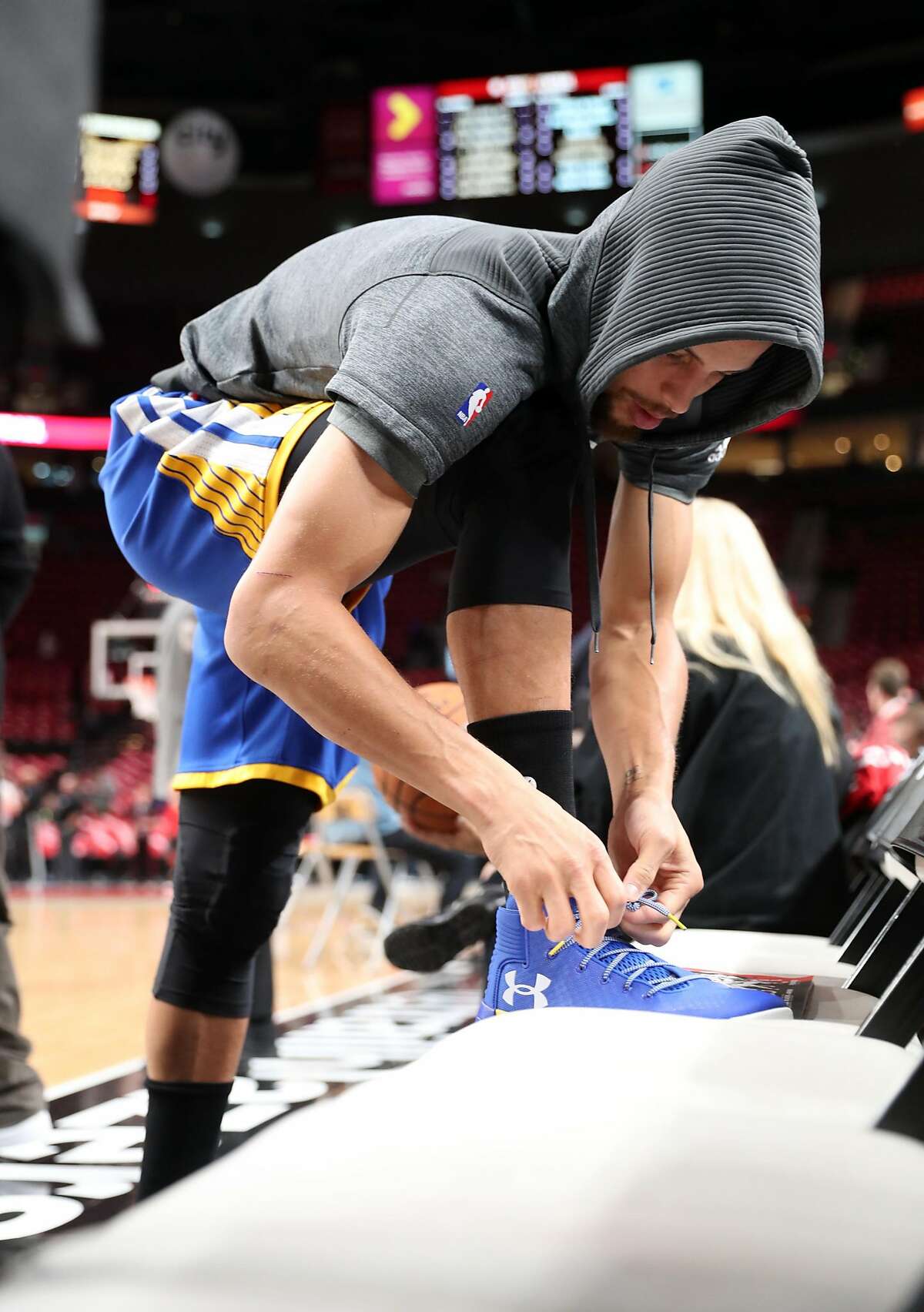 FILE-- Golden State Warriors' Stephen Curry ties his shoe prior to warming up before Warriors play Portland Trail Blazers in Game 3 of NBA Western Conference 1st Round Playoffs at Moda Center in Portland, Oregon on Saturday, April 22, 2017.