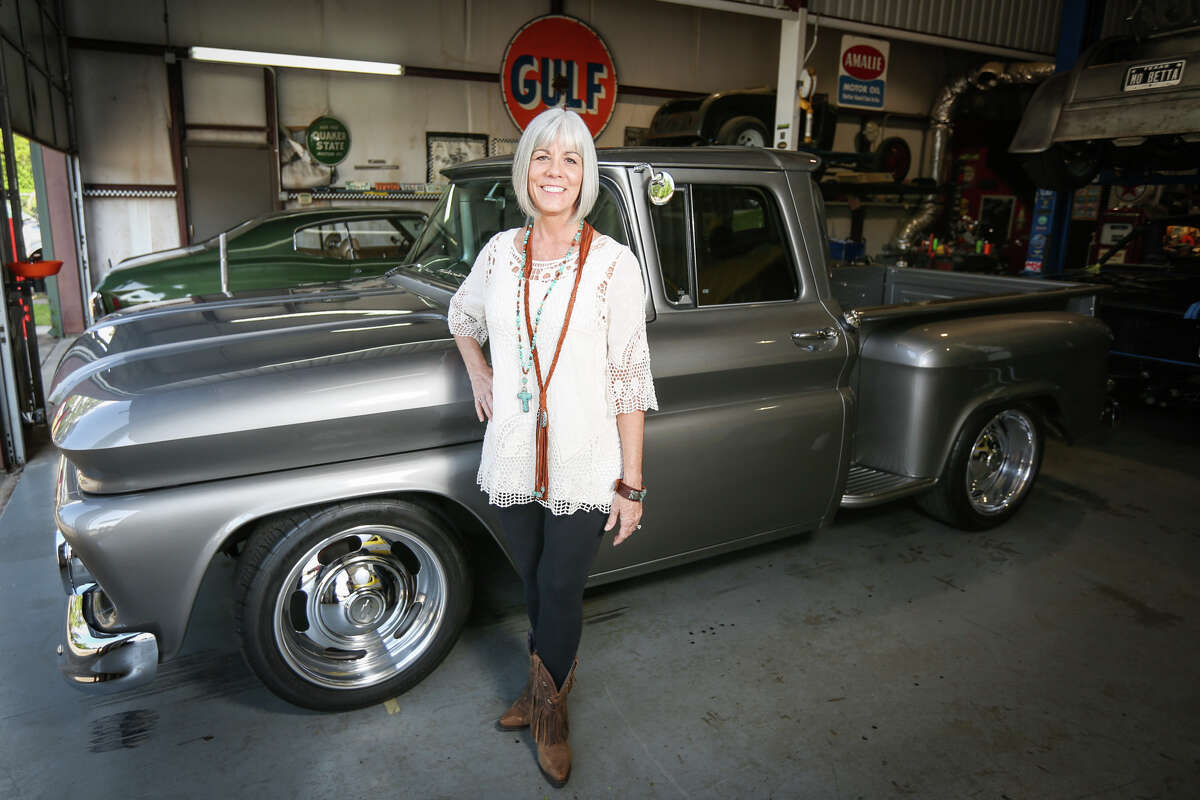 Owner Ann Henry poses for a portrait in front of her restored 1962 Chevy Stepside Pickup on Friday, April 21, 2017, at Mo' Muscle Cars.