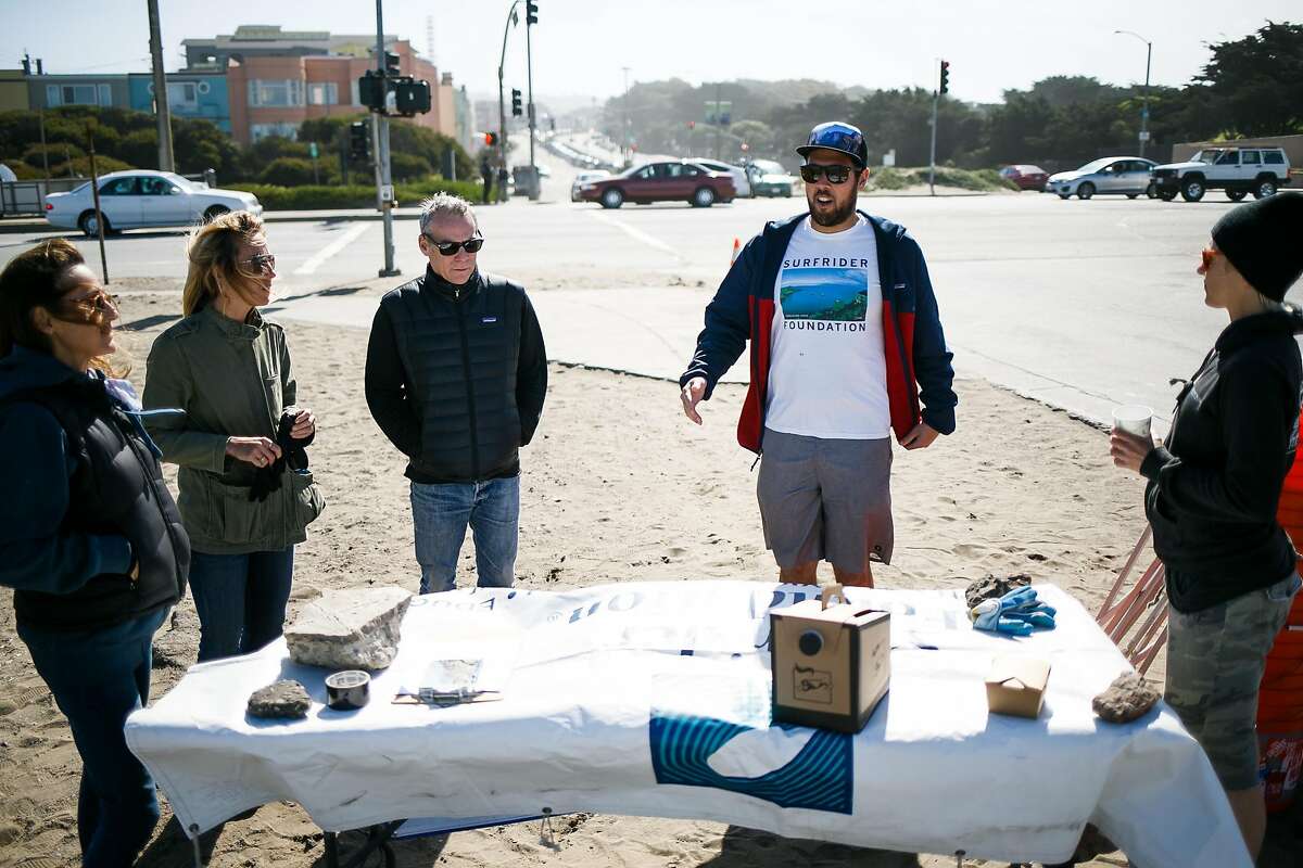 Chair of the Surfrider Foundation San Francisco chapter, Max Ernst, center right, talks to volunteers before the start of the Surfrider Foundation's annual beach clean-up event at Ocean Beach in San Francisco, Calif. Sunday, April 23, 2017.