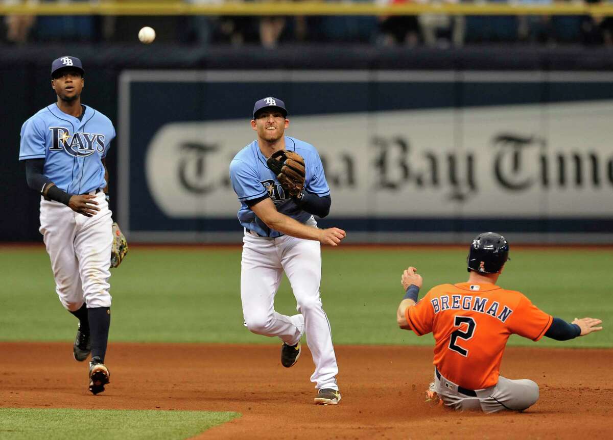 Tampa Bay Rays shortstop Tim Beckham, left, looks on as Brad Miller, center, throws to first to complete a double play after forcing out Houston Astros' Alex Bregman (2) at second base during the fourth inning of a baseball game Sunday, April 23, 2017, in St. Petersburg, Fla. (AP Photo/Steve Nesius)