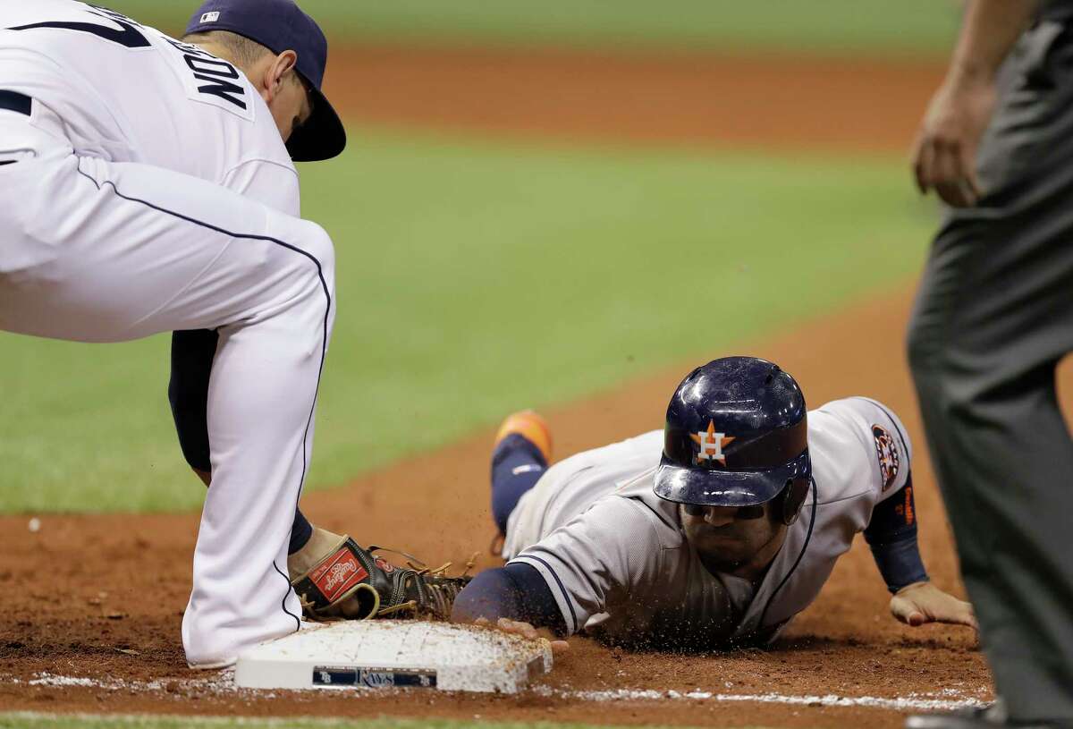 =Houston Astros' Jose Altuve dives back safely on a tag by Tampa Bay Rays' Logan Morrison on a pickoff throw during the sixth inning of a baseball game Saturday, April 22, 2017, in St. Petersburg, Fla. (AP Photo/Chris O'Meara)