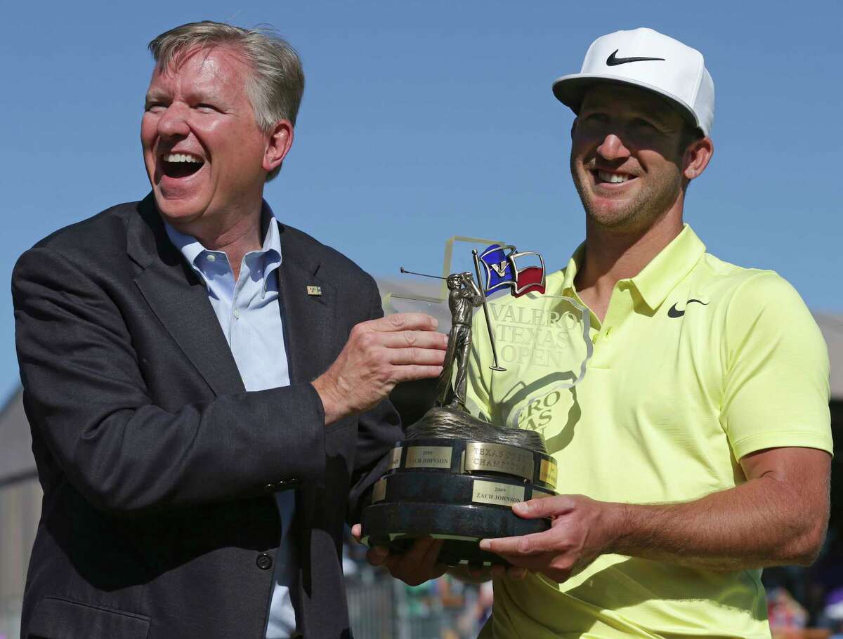 Kevin Chappell is handed the trophy by Valero's Gary Simmons after the final round of the Valero Texas Open at TPC San Antonio Oaks Course on April 23, 2017.
