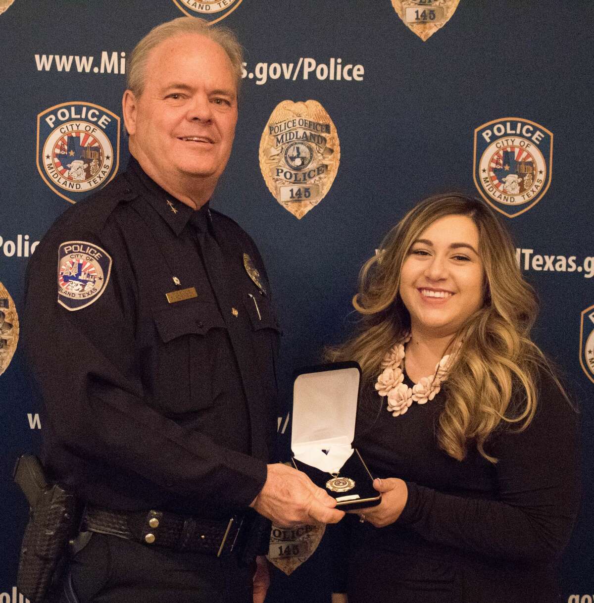 The Midland Police Department held its 25th annual awards banquet April 13  at Midland Country Club. Police Chief Price Robinson presents the Medal of Servce to Jessica Rodriguez. Other recipients were Lt. B.J. Land, Sgt. David Scardino, Detective Kay Therwanger and Officer Kenneth Callahan.