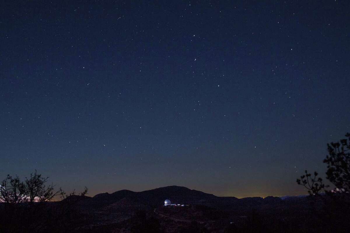 Looking in the direction of Balmorhea, stars appeared above the mountains and the Hobby-Eberly Telescope at the McDonald Observatory near Fort Davis, Texas on March 27, 2017. The view from the observatory now includes the glow from the Permian Basin oil field, incandescent with the work of 24-hour drilling, fracking and gas flaring.