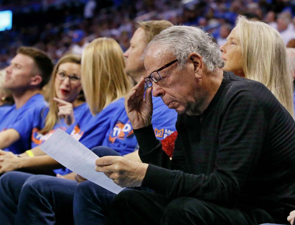 Leslie Alexander, owner of the Houston Rockets, looks over a stat sheet during the third quarter of the team's first-round NBA basketball playoff game against the Oklahoma City Thunder in Oklahoma City, Friday, April 21, 2017. Oklahoma City won 115-113. (AP Photo/Sue Ogrocki)